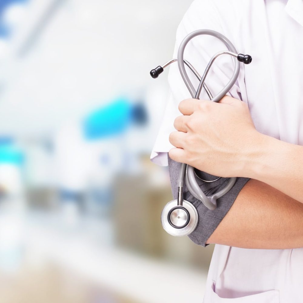 Doctor with a stethoscope in the hands and hospital background Doctor with a stethoscope in the hands and hospital background